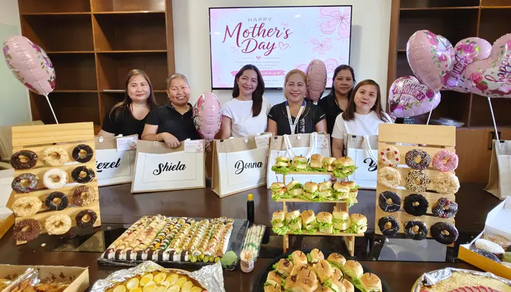 Pinnacle Homes employees celebrating Mother’s Day 2025 with gifts and shared food at the Head Office